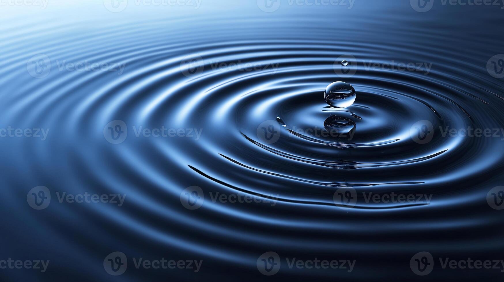 Water droplet impacting calm water, creating concentric ripples. photo