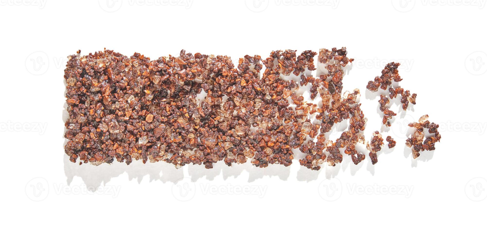 Dried organic red quinoa grains spread on white background casting shadows. photo