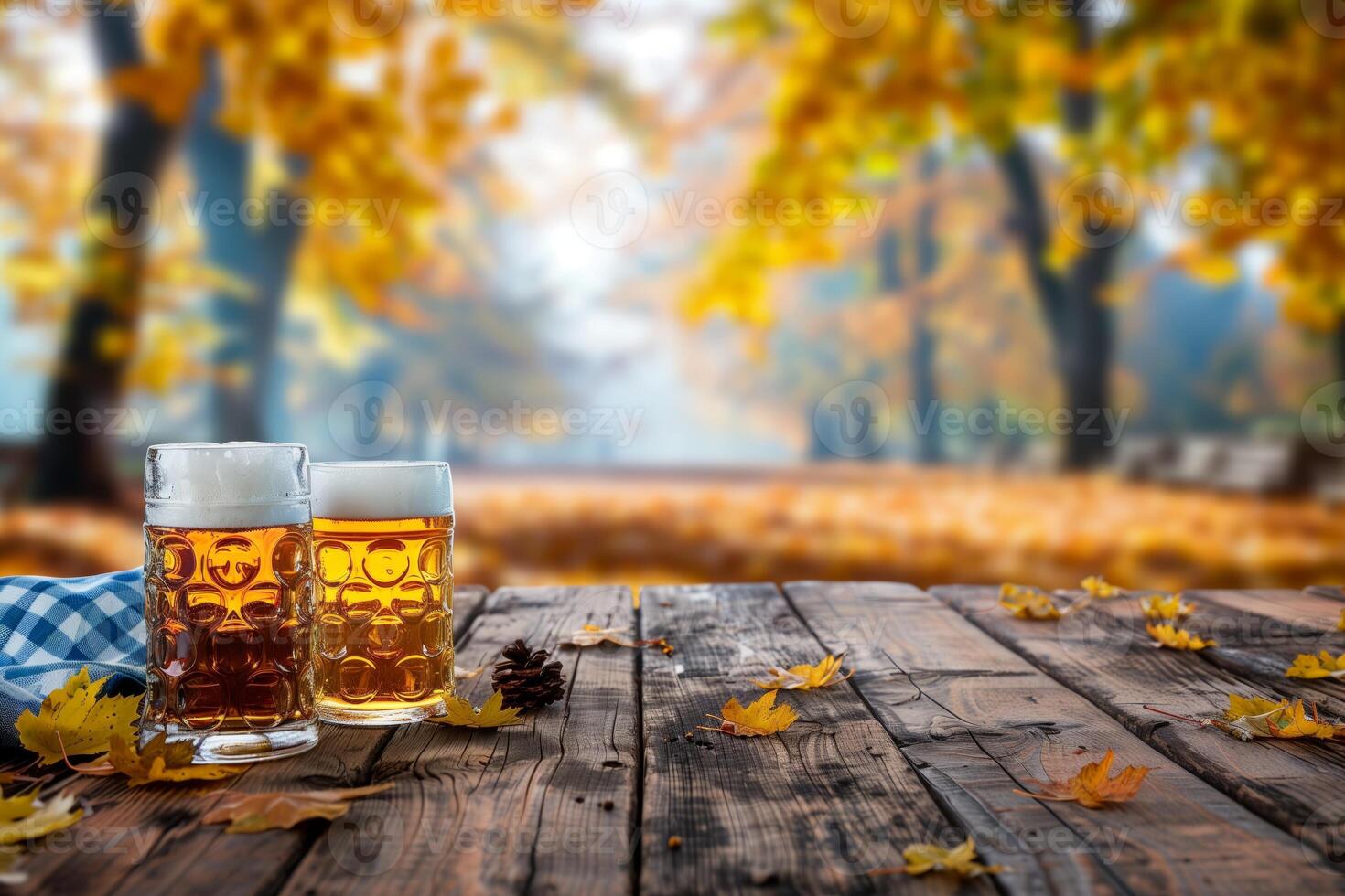 Two glasses of beer on a rustic wooden table surrounded by autumn leaves with a blurred forest background photo