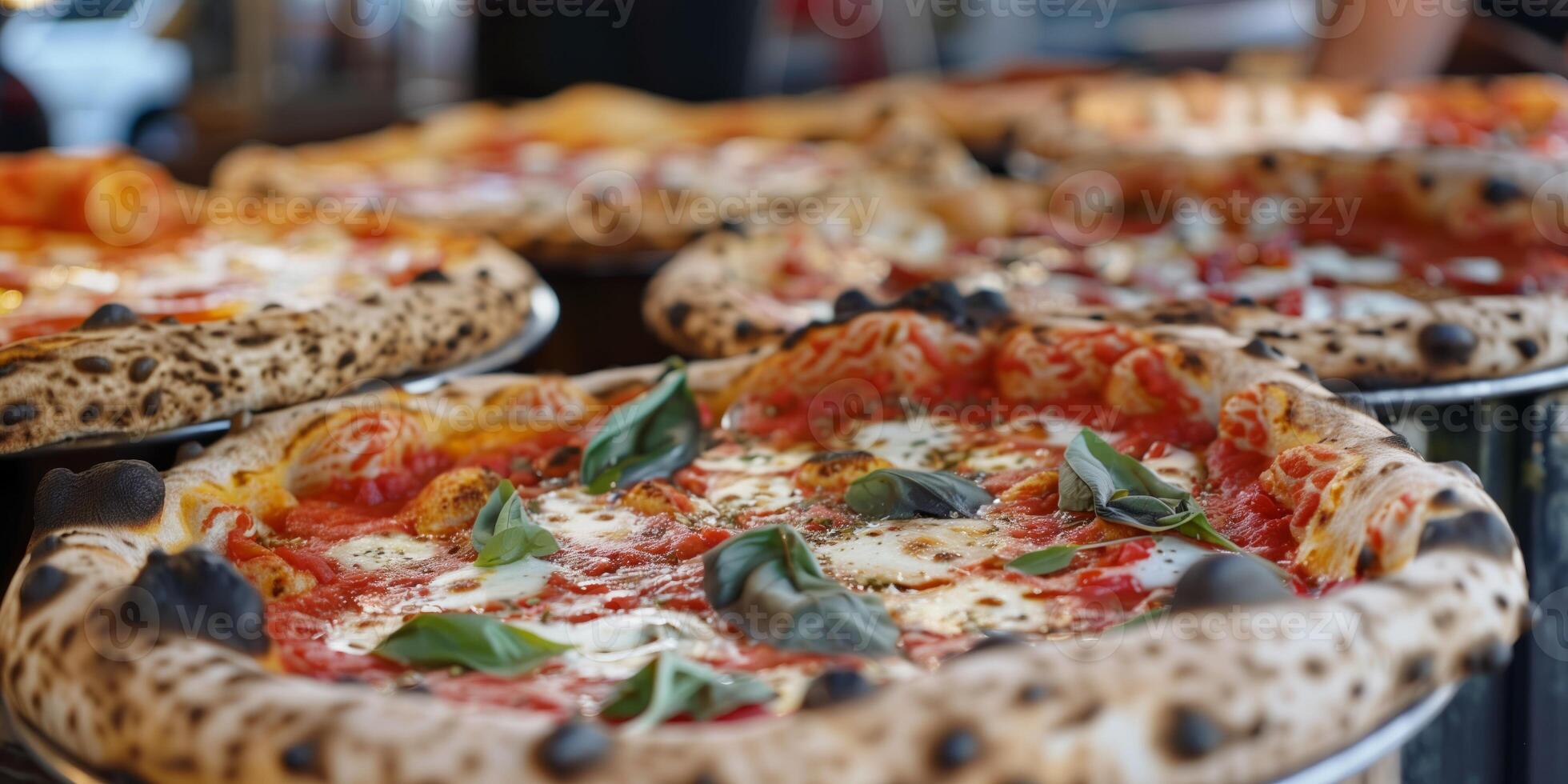 Wood-fired Neapolitan pizzas with charred crusts, fresh tomato sauce, melted mozzarella, and basil leaves, served hot and ready to enjoy photo