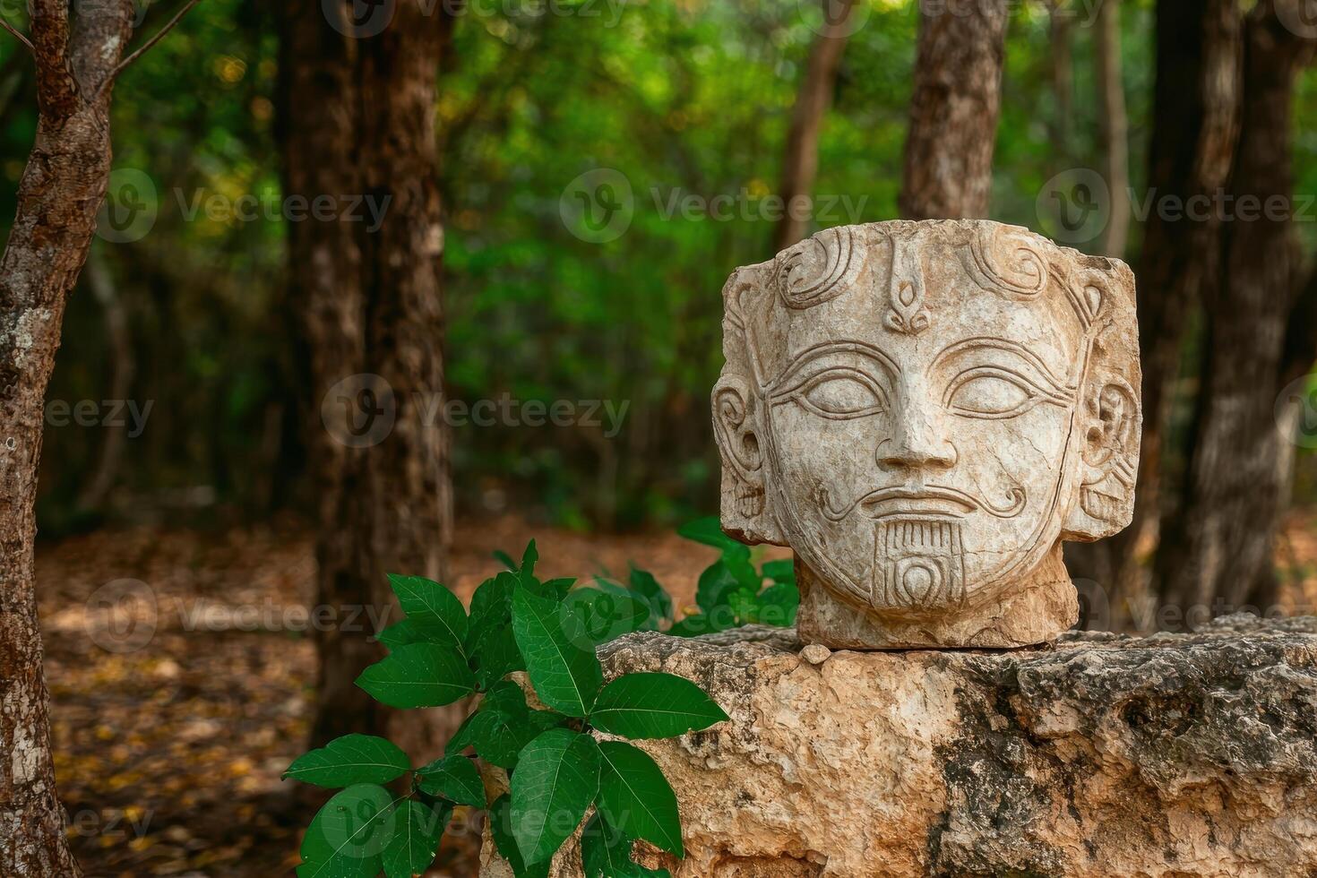 Ancient stone head sculpture in a forest setting photo