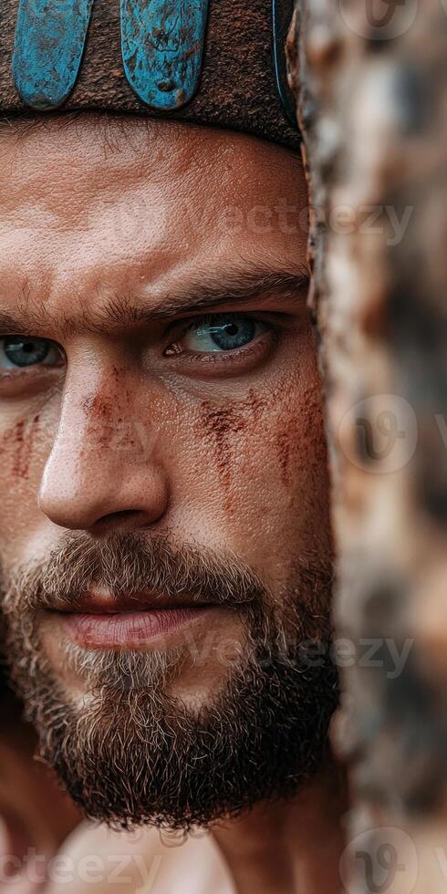 Close up portrait of a man with a beard and tribal markings photo