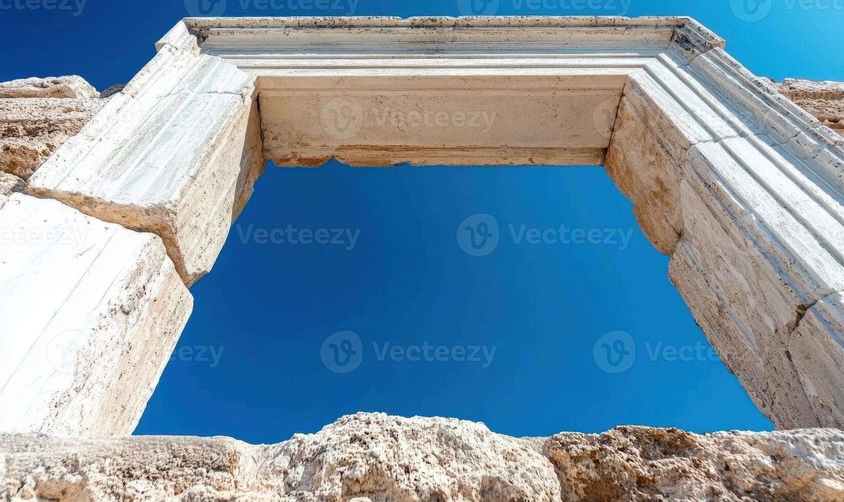 Ancient stone doorway against a bright blue sky photo