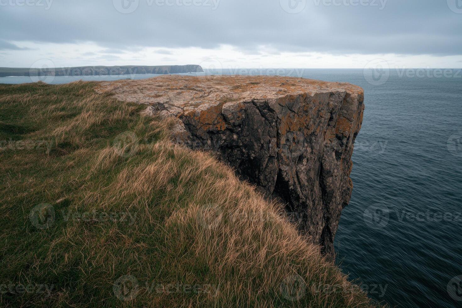 Dramatic cliff edge overlooking the ocean photo