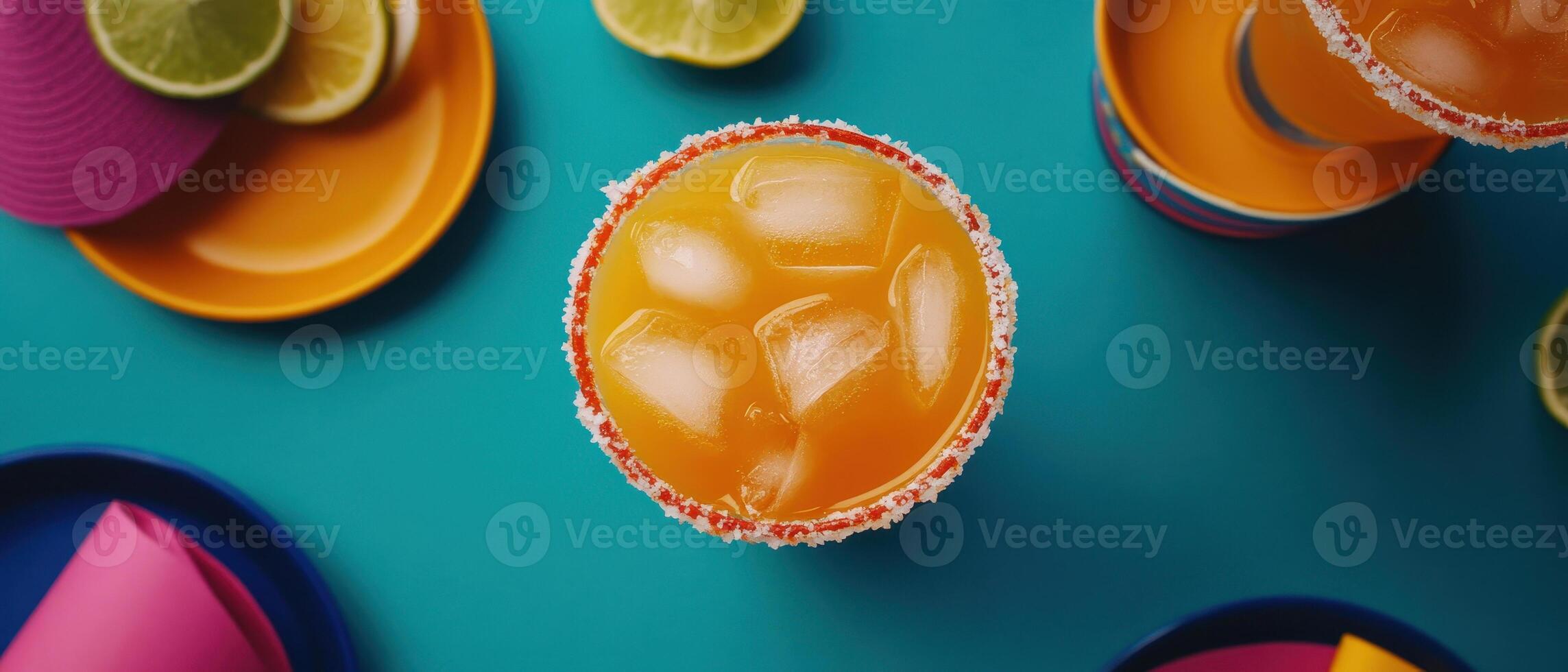 Refreshing orange cocktail with ice, vibrant plates, and lime slices photo
