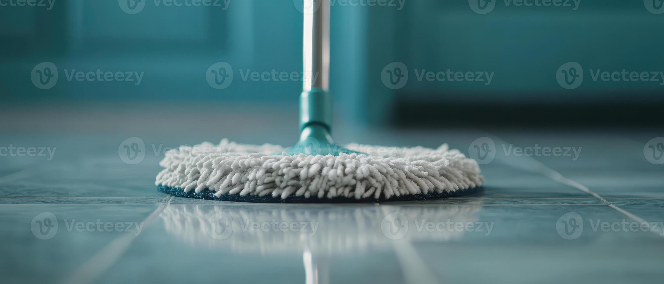 close up of mop gliding across glossy tiles, showcasing its cleaning action and shine of surface. vibrant background adds fresh feel to cleaning process photo