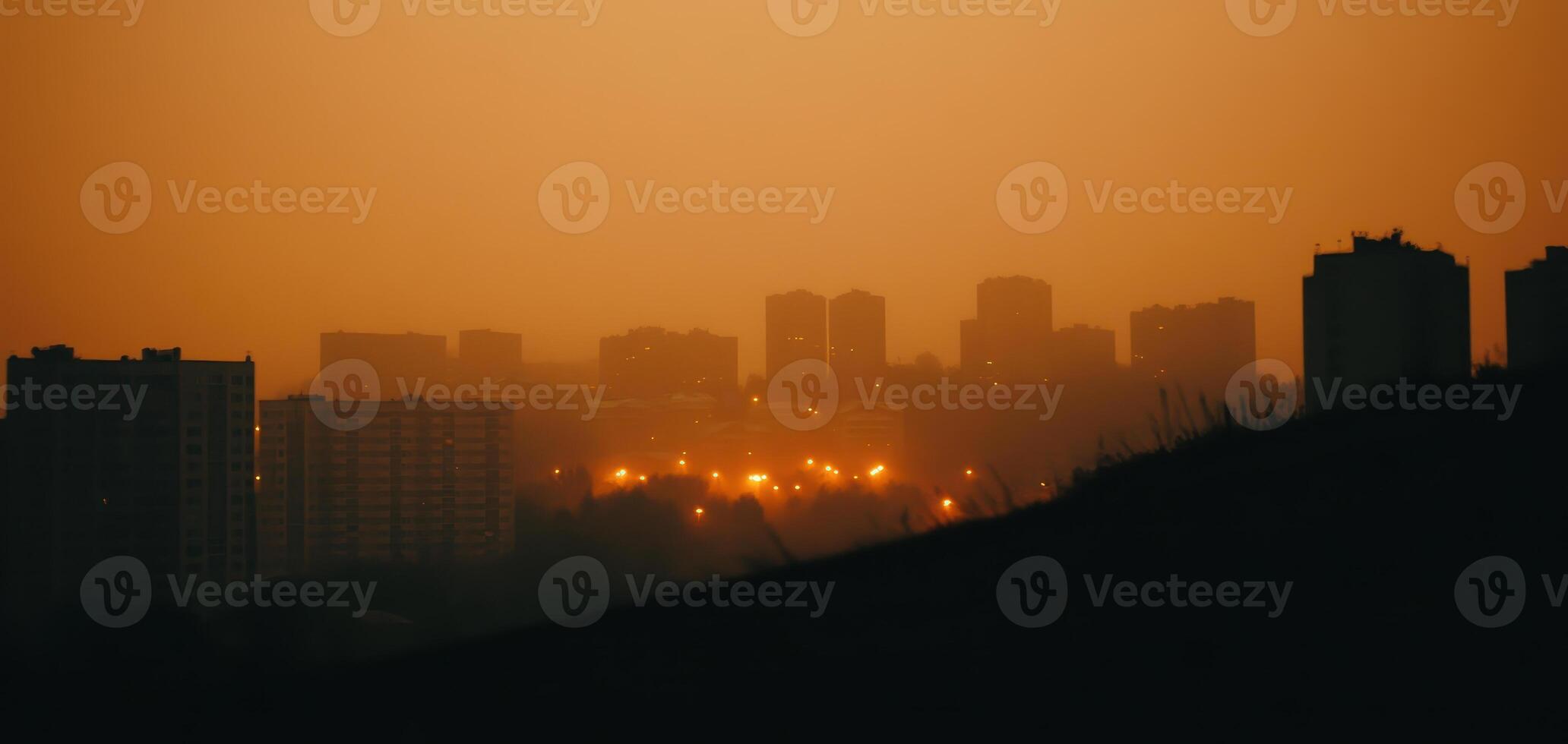 City lights glowing through layers of pollution create moody atmosphere at dusk. silhouettes of buildings stand against hazy orange sky, evoking sense of urban mystery photo