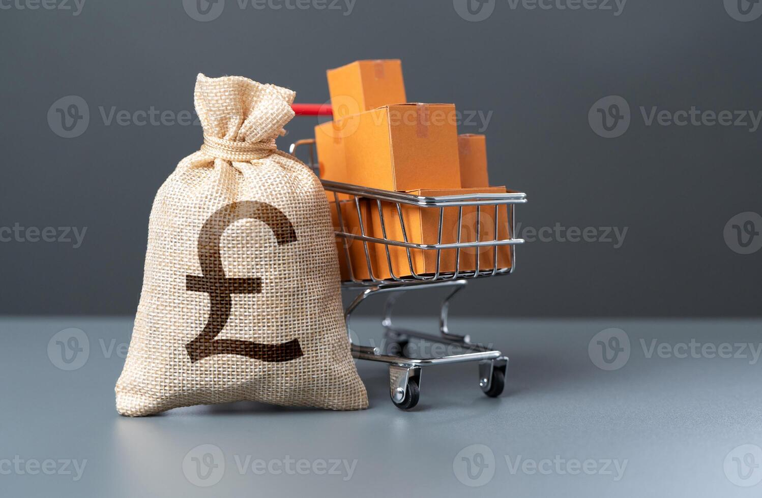 Shopping cart with boxes of goods and british pound sterling money bag. Profit from the sale of goods. Marketing and market research. Purchasing power of buyers. Start-up equipment purchase. photo