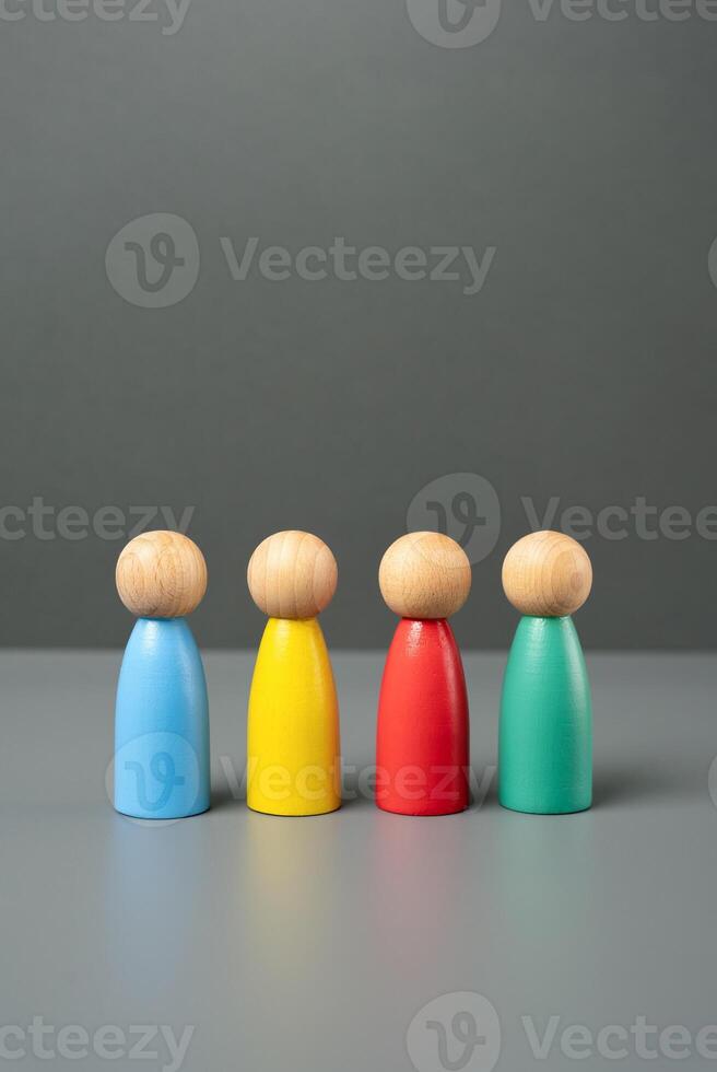 Multi-colored people figures. People representing different groups, communities and cultures. Consumer groups, their preferences and purchasing power. Marketing and segmentation. photo
