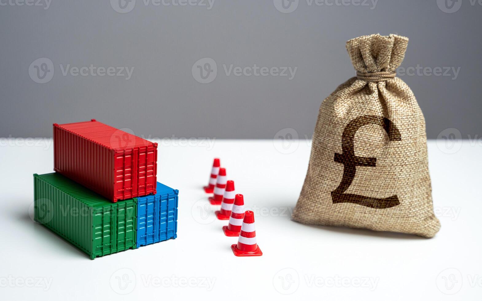 Shipping containers with goods and british pound sterling money bag are separated by a barrier. Break a trade deal. Economic sanctions. Naval blockade. Logistics difficulties. photo