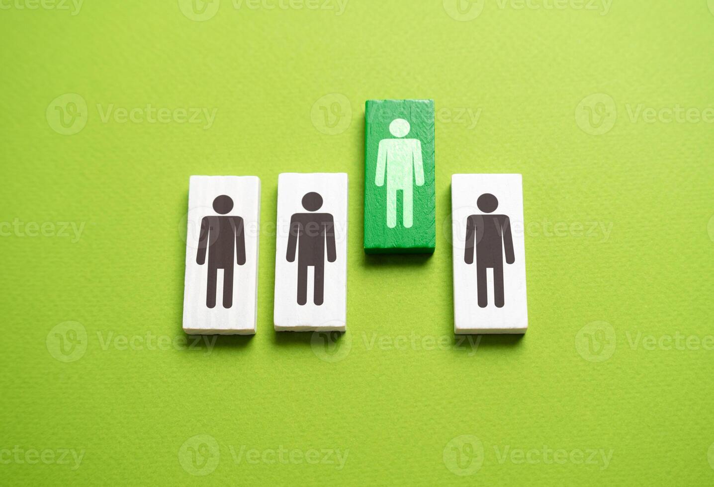 Green man selected from the line. Candidate for hiring. Winner of the competition. Talented and promising employee. Appointment to the post of manager. Promotion at work. photo