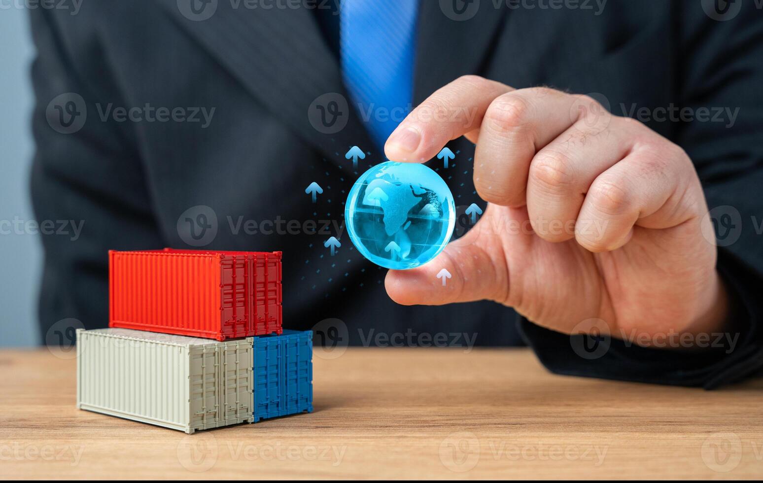 Businessman holding globe of planet Earth over stack of shipping containers. World trade and economic processes. Globalization. Import, export, transportation of goods and logistics. Production chains photo