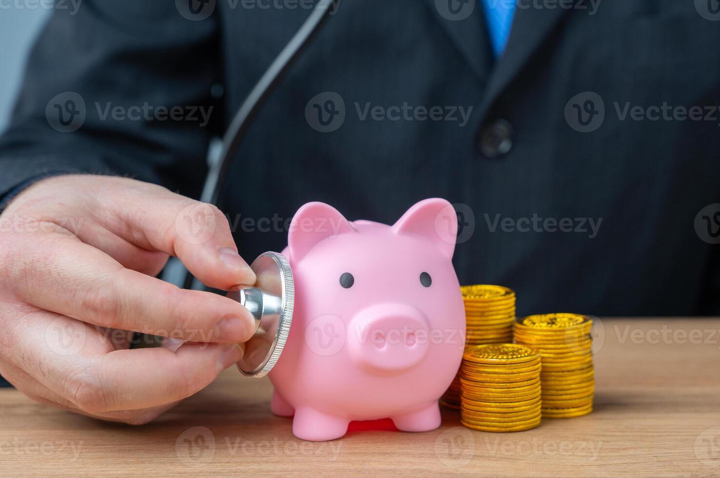 The businessman listens to the pig piglet with a stethoscope. Financial health. Liquidity of assets. Economic security. Accounting management. photo