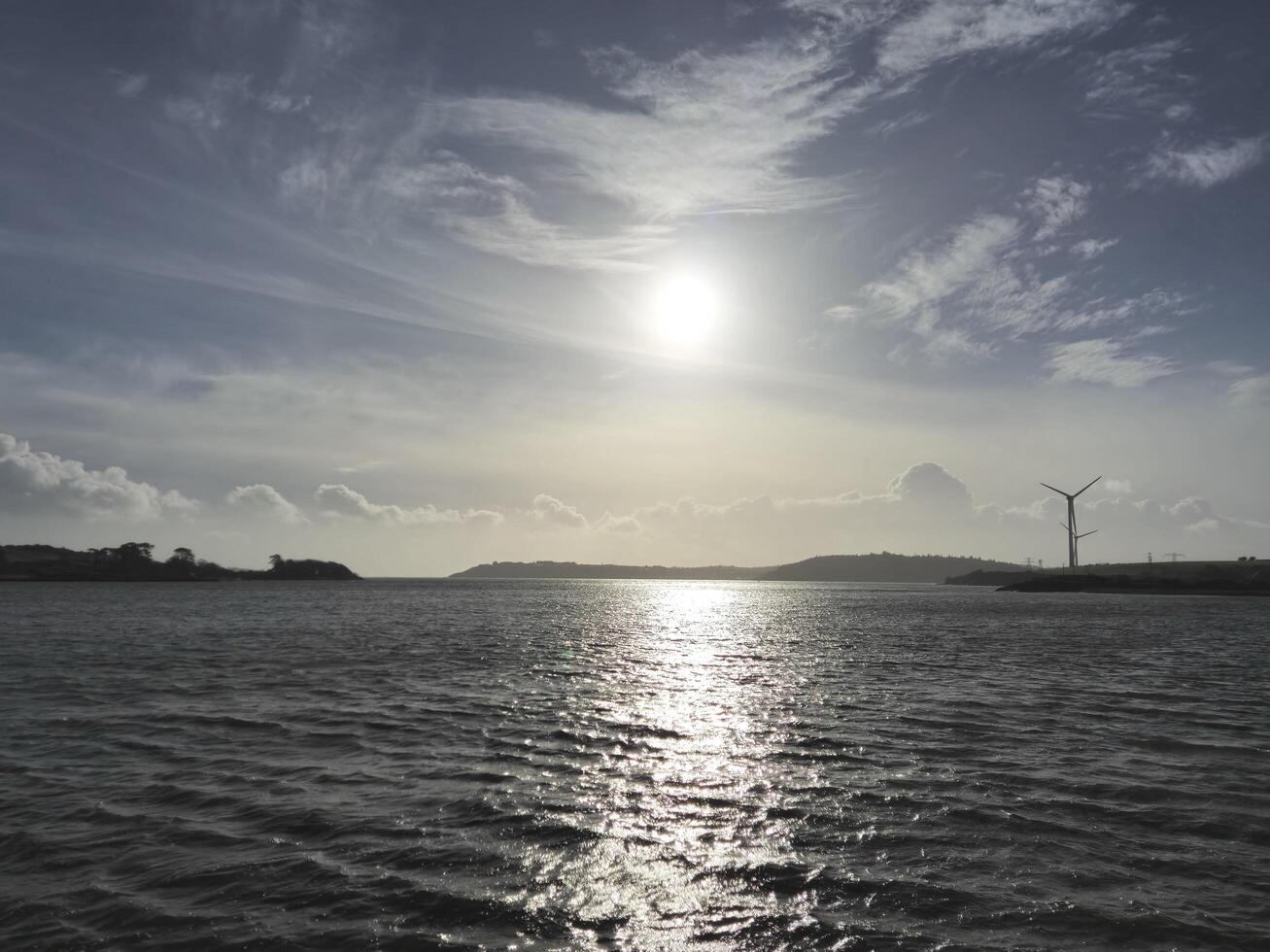 Spike Island in Ireland as it is seen from another island, with ocean waters and cloudy sky photo