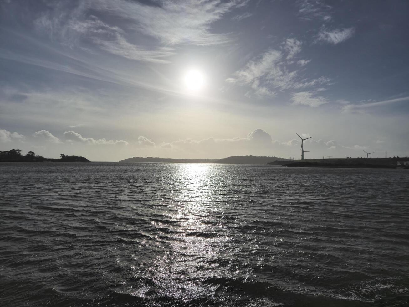 Spike Island in Ireland as it is seen from another island, with ocean waters and cloudy sky photo
