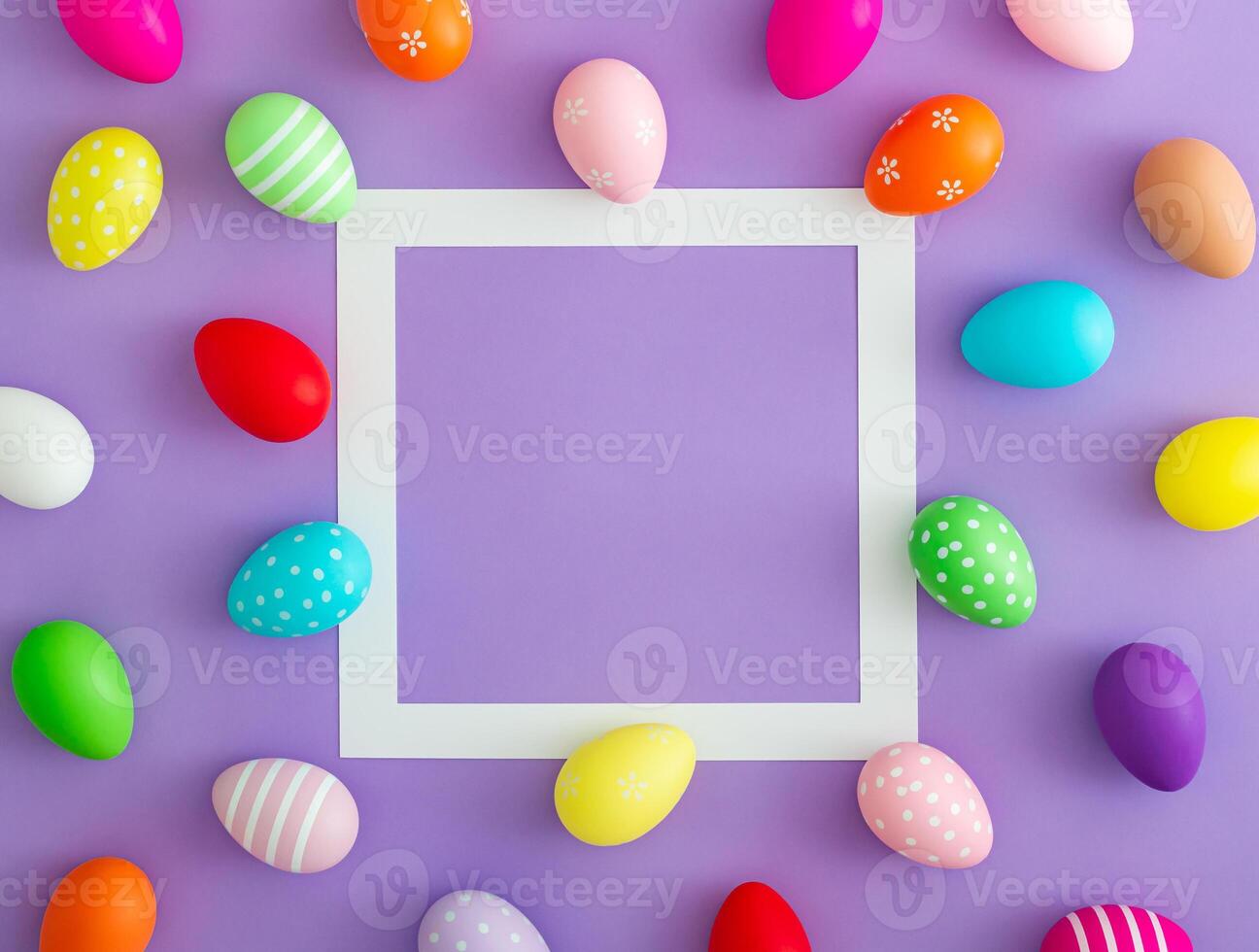 Trendy spring composition pattern made of colorful Easter eggs on purple background with copy space. Minimal Easter concept. Creative festive holiday layout. Easter aesthetic. Flat lay, top of view. photo