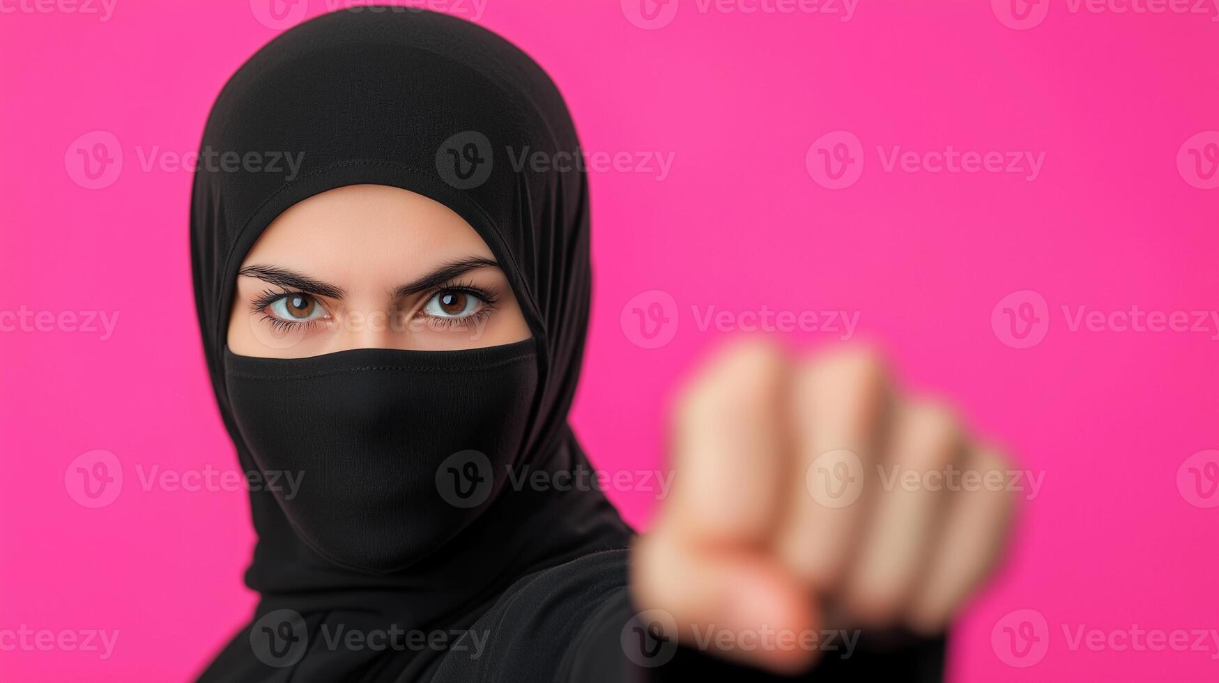Woman in Hijab Practicing Martial Arts Against Vibrant Pink Background Exhibiting Strength and Focus in Modern Self Defense and Cultural Expression photo