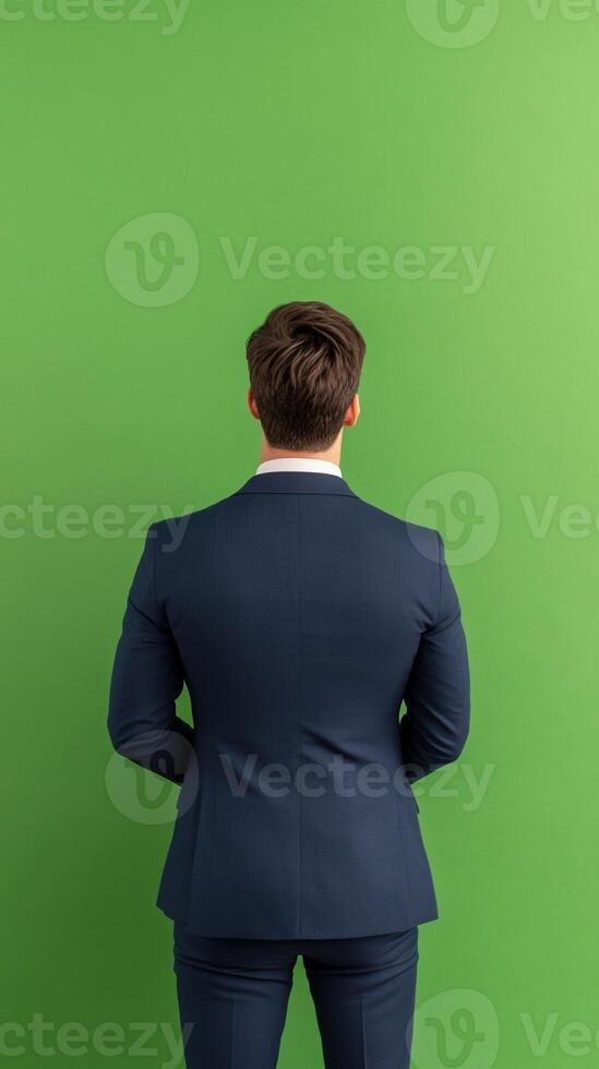 Professional Real Estate Agent in Suit Facing Green Screen Background for Digital Visual Content Production and Marketing photo