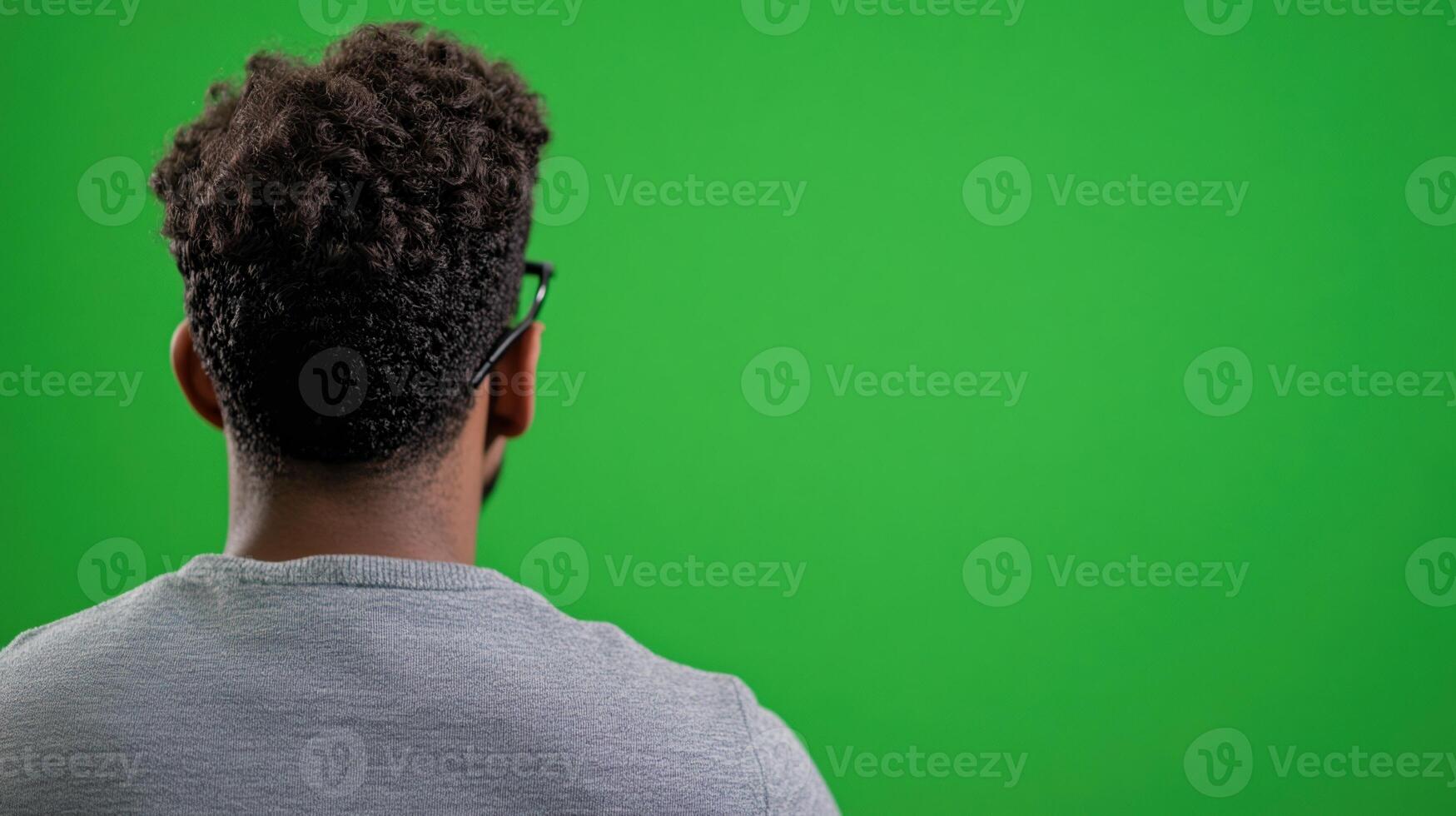 Man in Grey Shirt Facing Green Screen in Coding Workshop for Tech Design and Interactive Media Projects photo