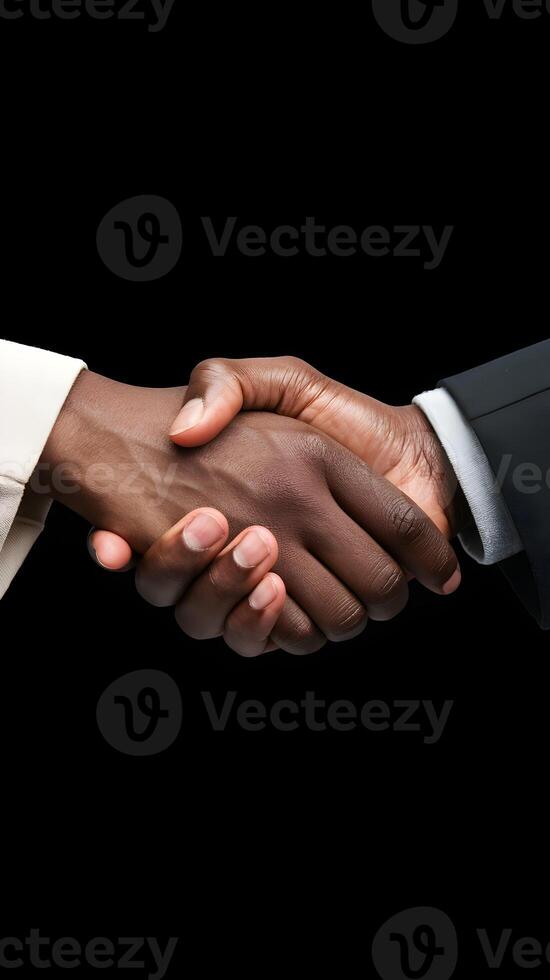 Two hands, dark-skinned and light-skinned, clasp firmly, symbolizing unity and collaboration. Vertical Mobile Wallpaper photo