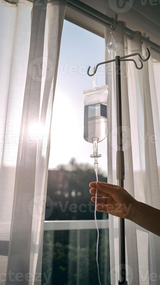 IV bag held before white curtains, soft sunlight emphasizing healing and serene recovery Vertical Mobile Wallpaper photo