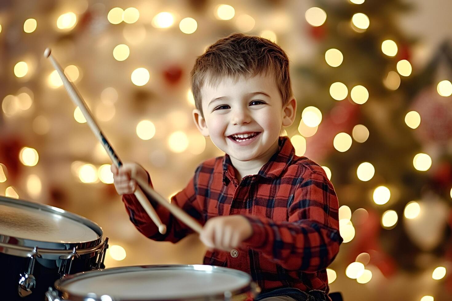 Little boy playing drums on christmas eve photo
