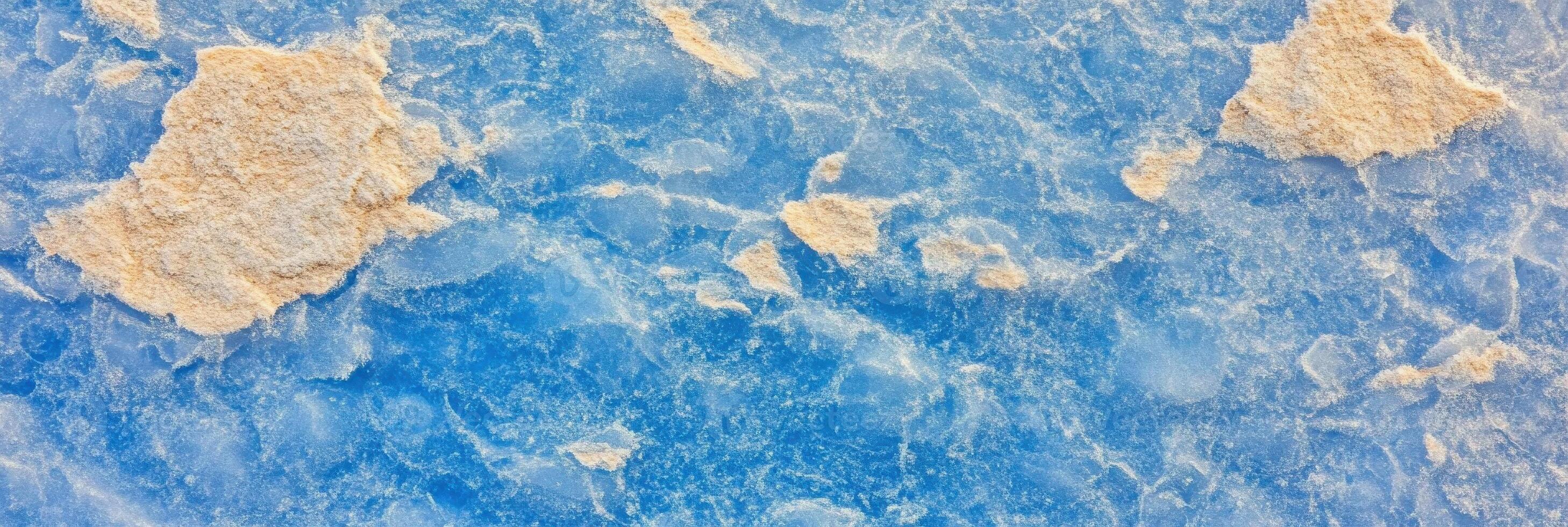 Aerial view of salt crystals on vibrant blue water in natural landscape photo