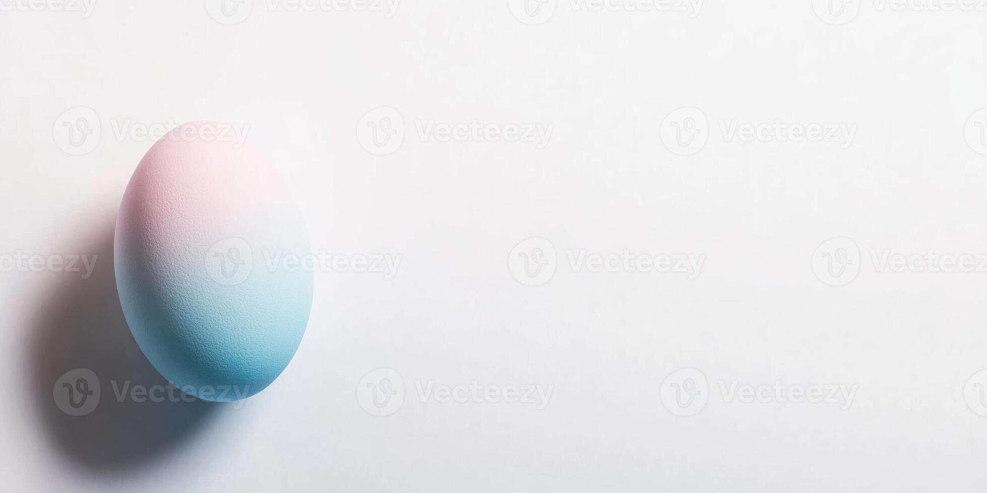 Pastel gradient egg on minimal white background for easter and spring themes photo