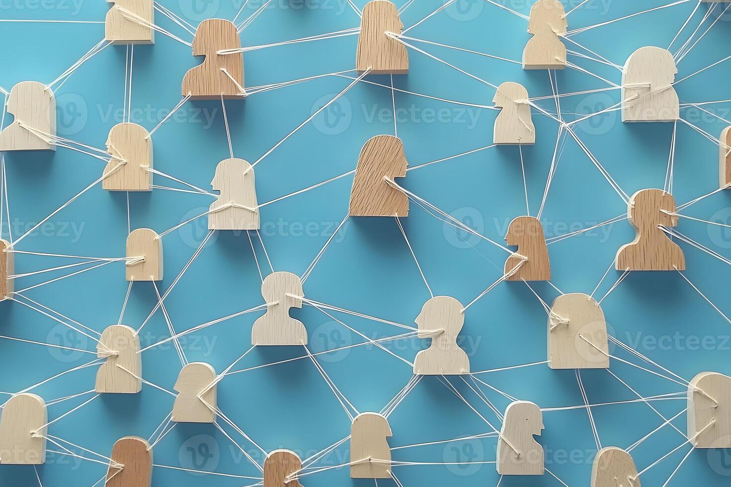Wooden figures interconnected by strings forming a network photo