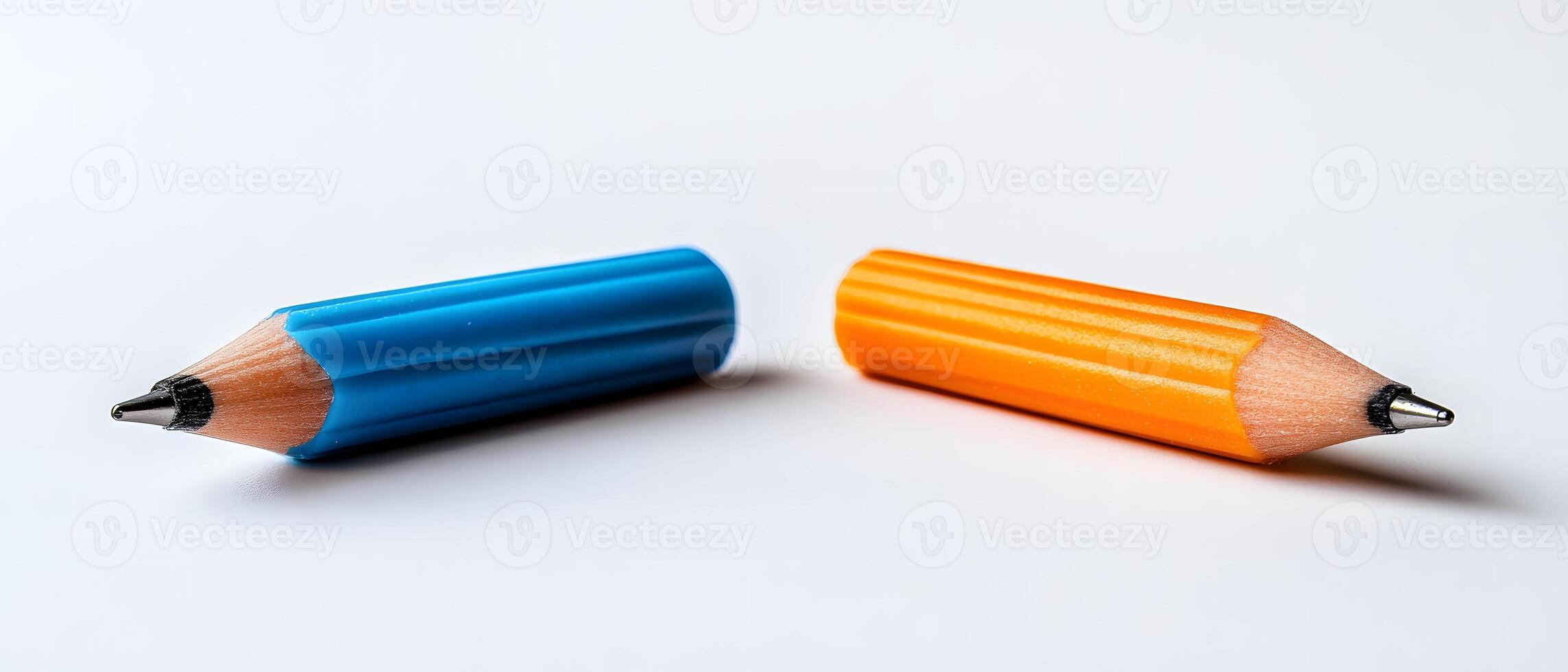 Two colored pencils lying on a white background photo