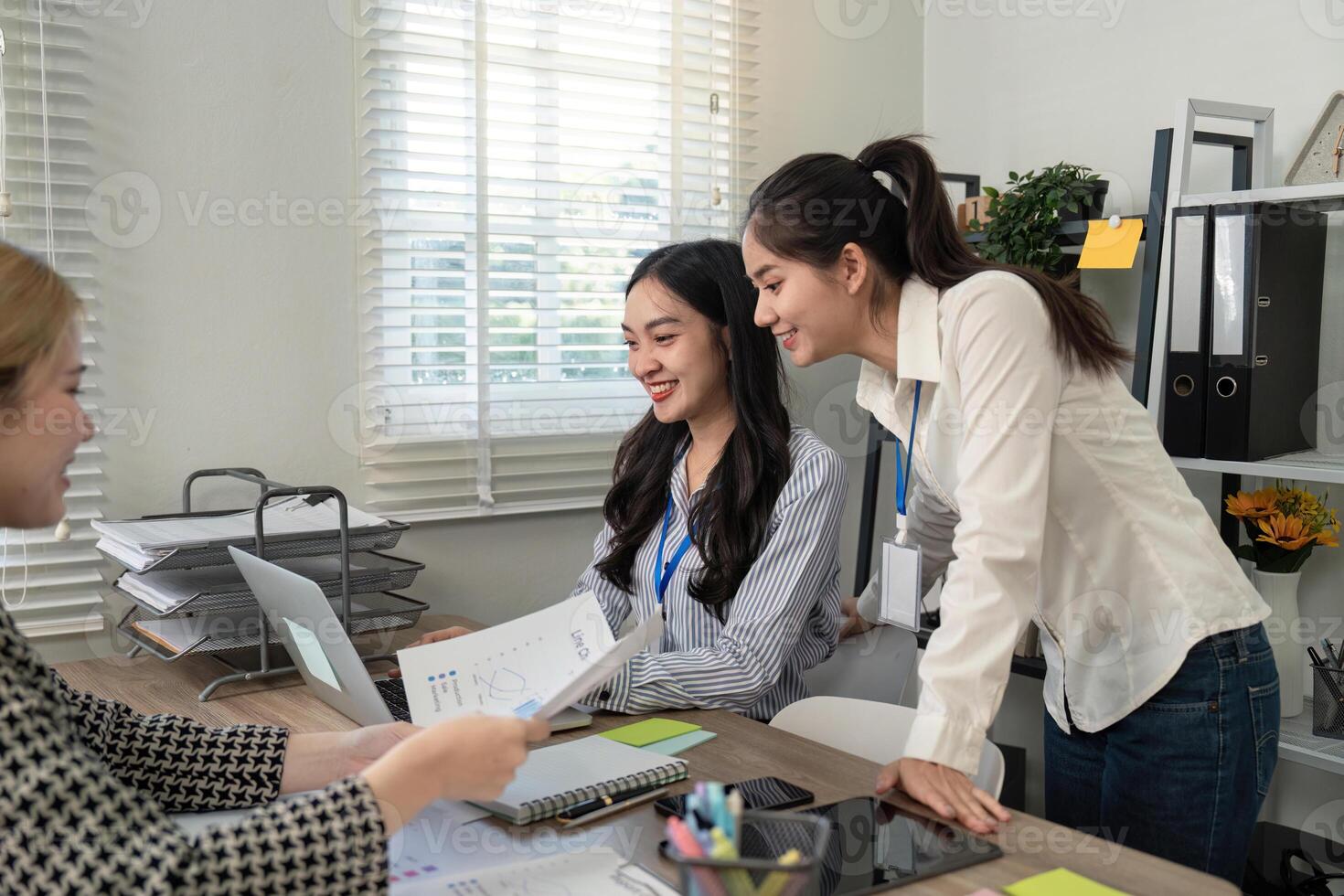 Business team collaborating and analyzing data in a modern office setting photo