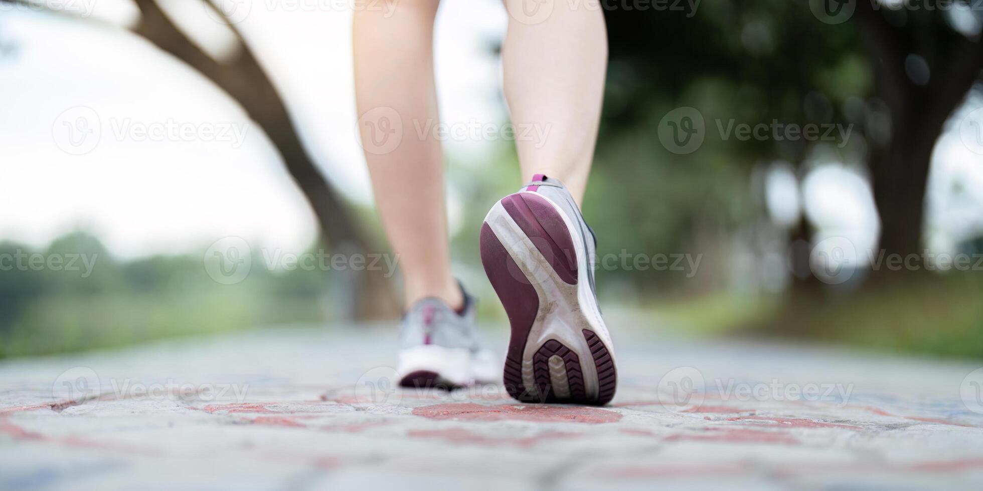 Close up of woman running shoes on a picturesque path, emphasizing fitness and active lifestyle photo
