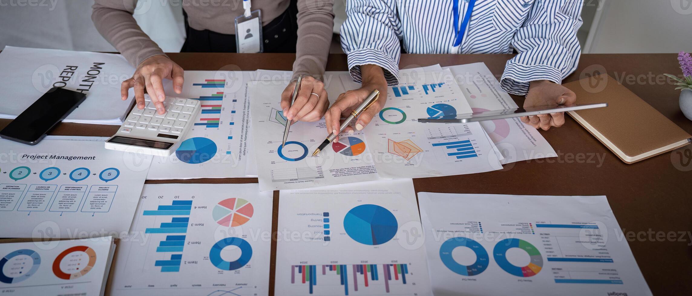 Business team analyzing project management charts and data in a modern office meeting photo