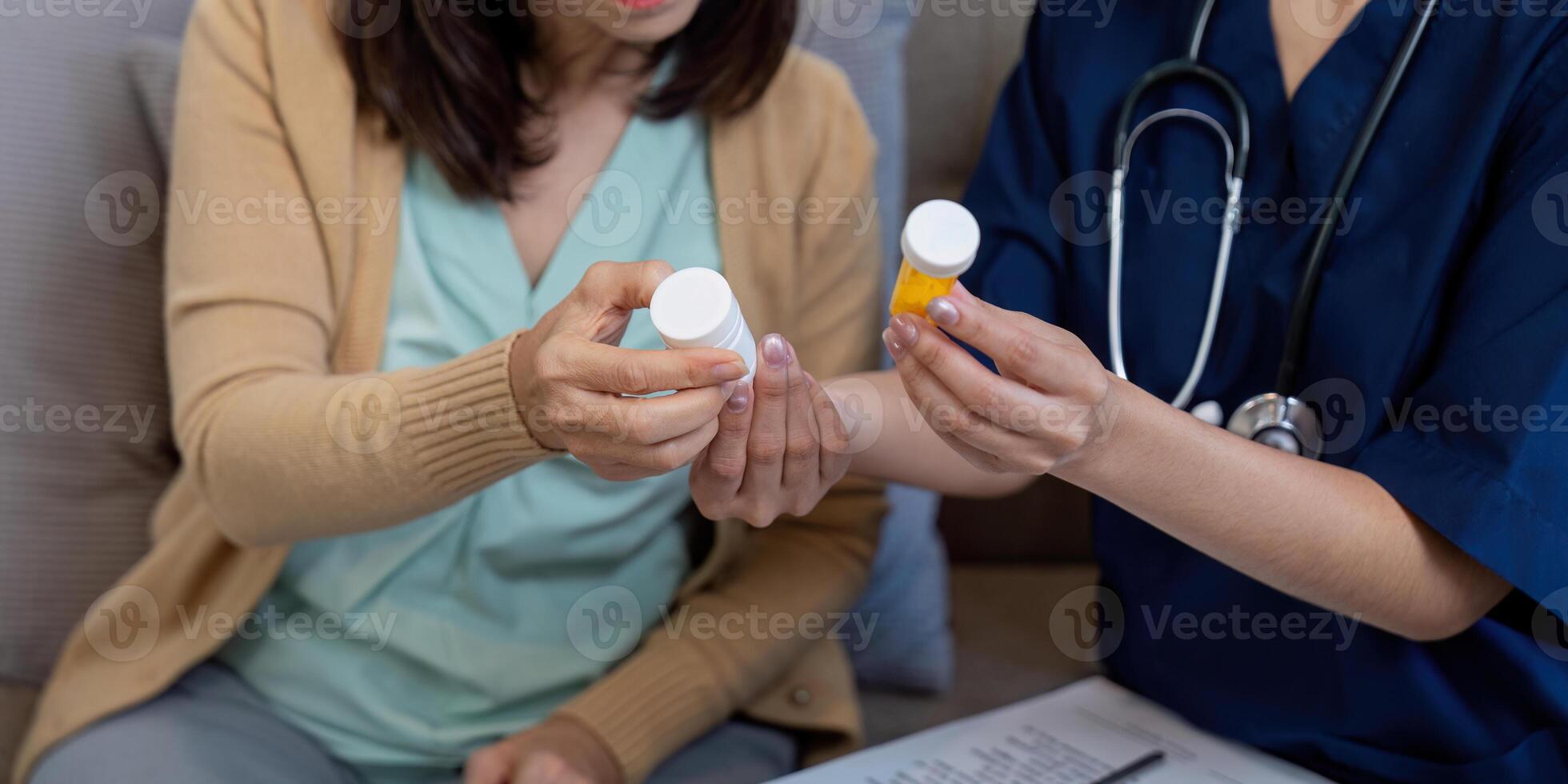 Caregiver discussing medication with elderly patient, addressing disease symptoms and health management photo