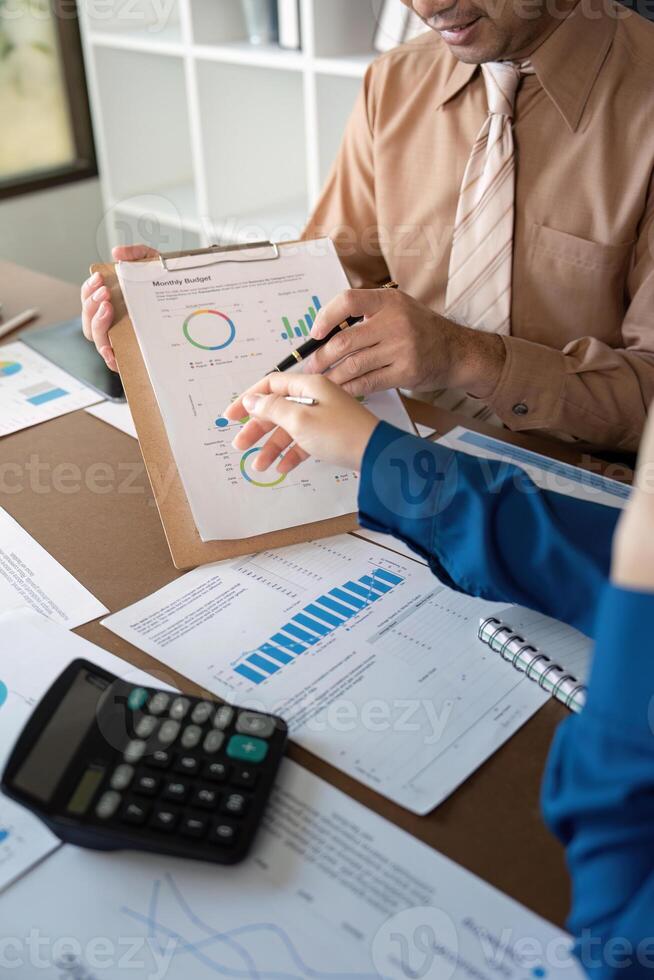Accountants reviewing monthly budget and financial growth metrics in a sleek office photo