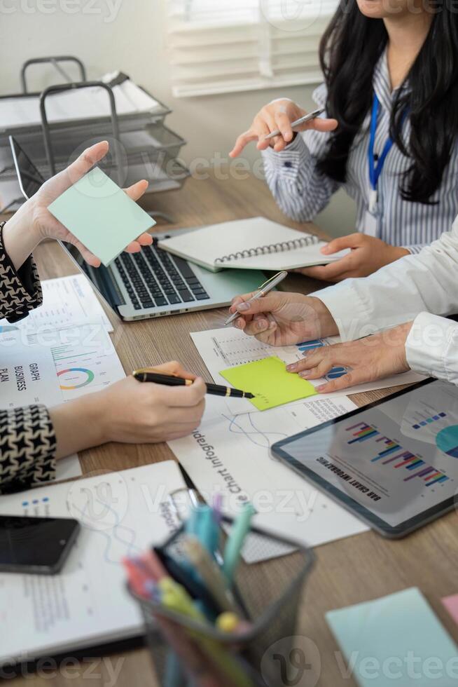 Dynamic team discussing data insights and brainstorming ideas with sticky notes in a collaborative office meeting photo
