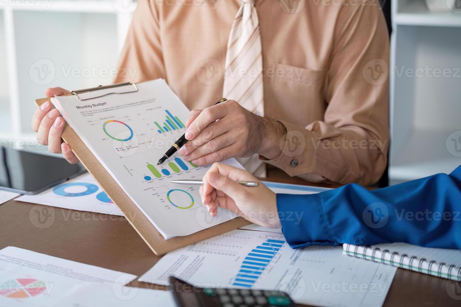 Accountants reviewing monthly budget metrics and performance charts in a sleek office photo