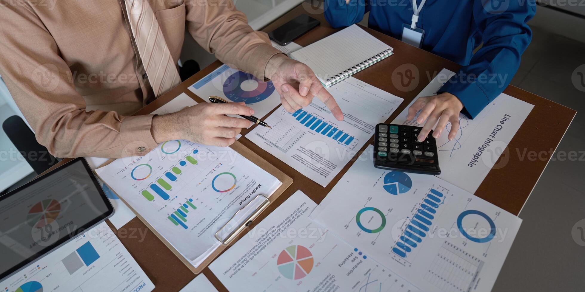 Accountants collaborating on financial analysis and performance metrics in a modern workspace photo
