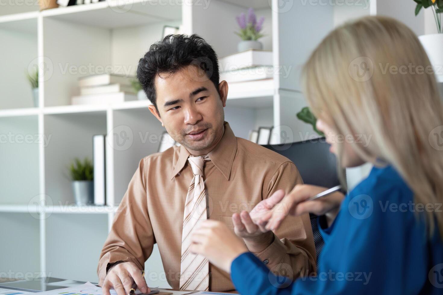 Business professionals discussing strategies in a modern office setting photo