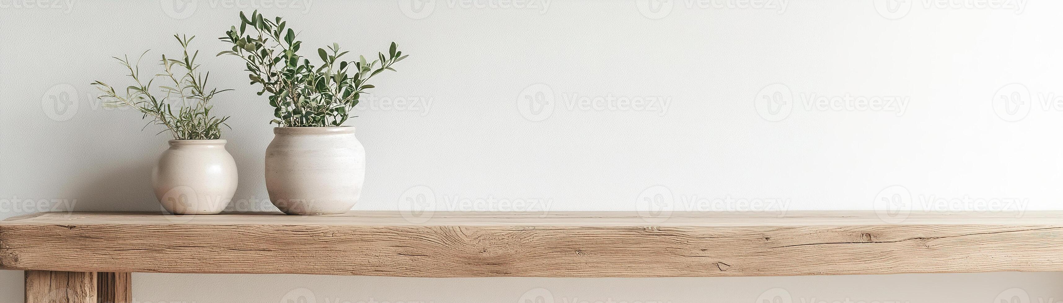 A reclaimed wooden table embraces minimalism with small ceramic pots of greenery. The clean white wall offers negative space, creating a serene and natural atmosphere ideal for decoration photo