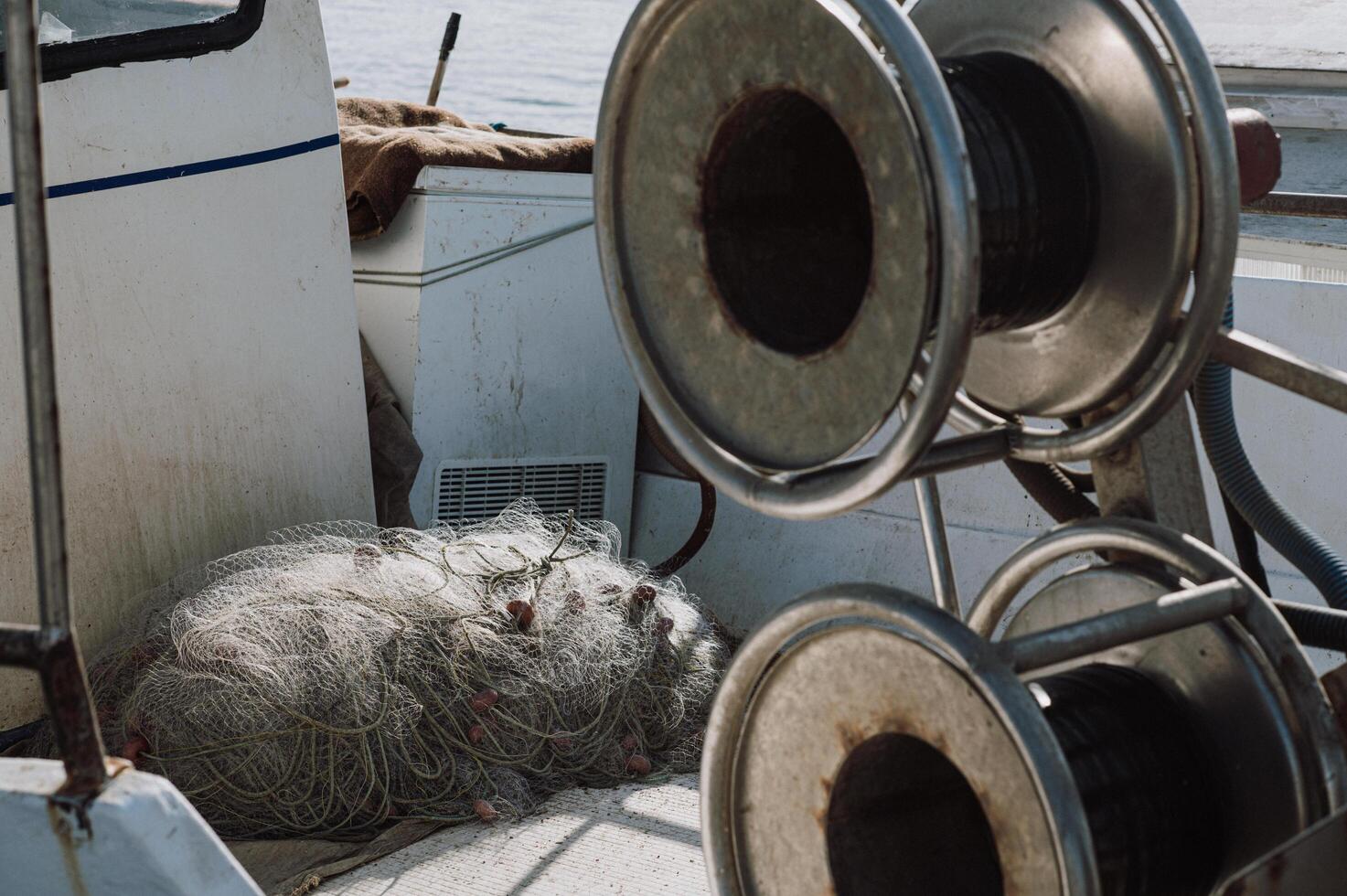 Nets and reels rest in the fishing boat, ready for the next catch. photo