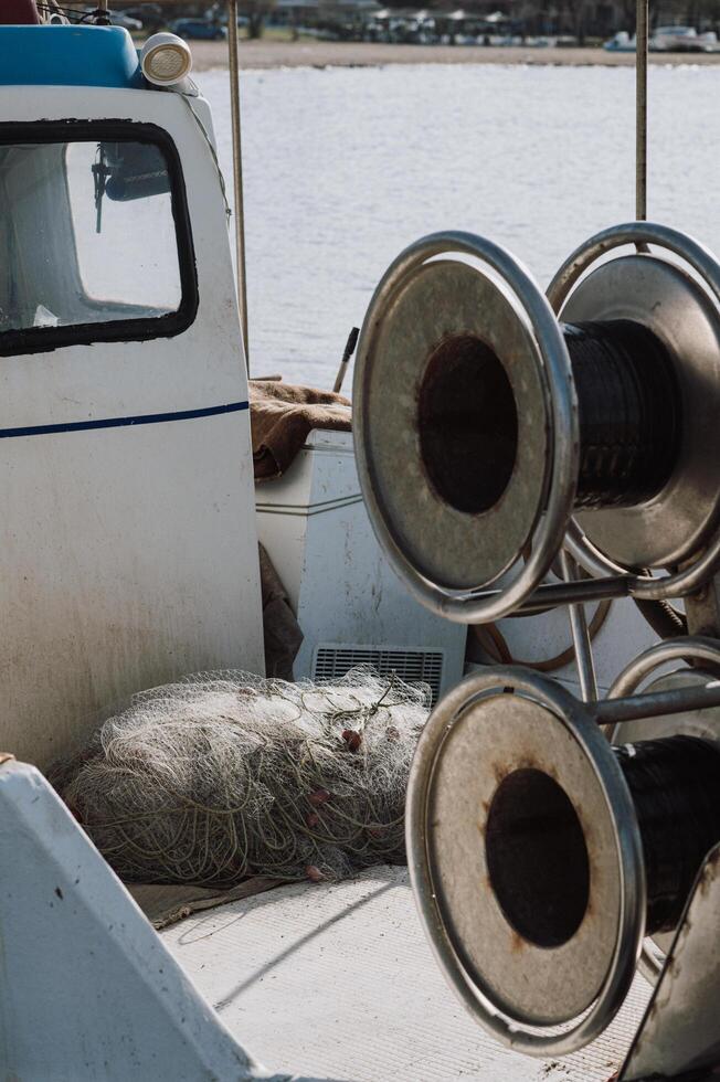 Fishing reels and nets lie neatly arranged in a fishermans boat photo