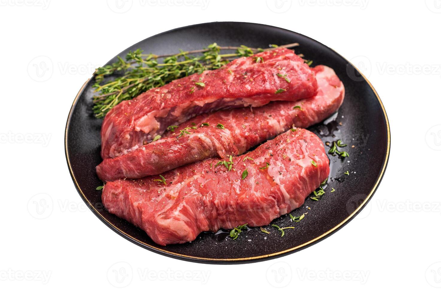 Tri tip steaks, Raw marbled beef meat on plate with herbs isolated on white background photo