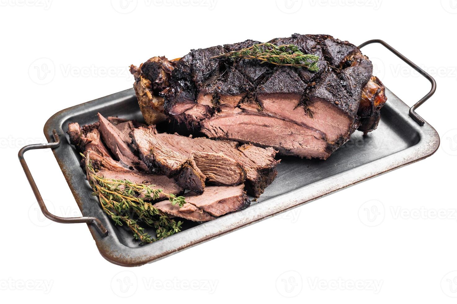 Roasted game meat of Venison, baked leg of roe deer on a tray with herbs isolated on white background. top view photo