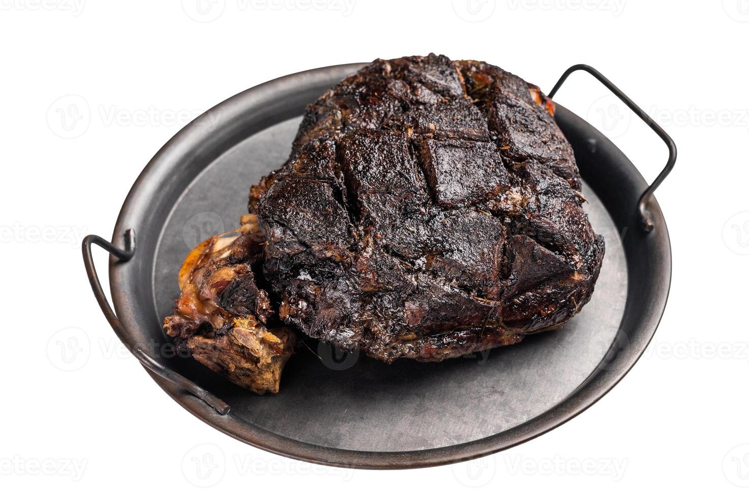 Slow cooked venison roast leg. Braised game meat of deer with bone isolated on white background. top view photo