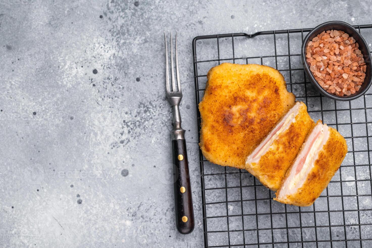 Fried Chicken cordon bleu cutlet with cheese and ham in breadcrumbs. grey background. top view photo