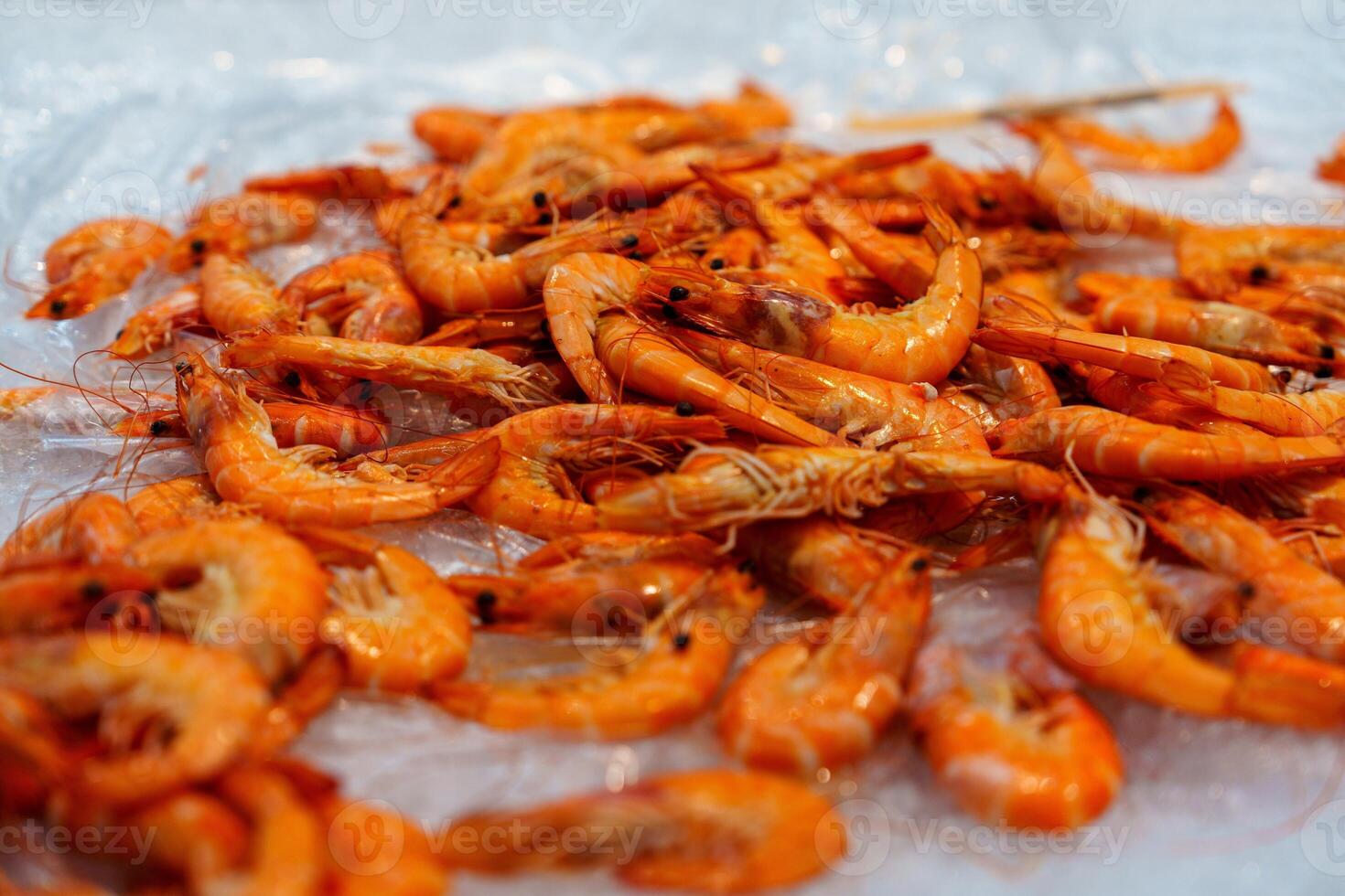 Freshly Cooked Tiger Prawns on Ice for Sale at a Bustling Local Seafood Market Experience photo