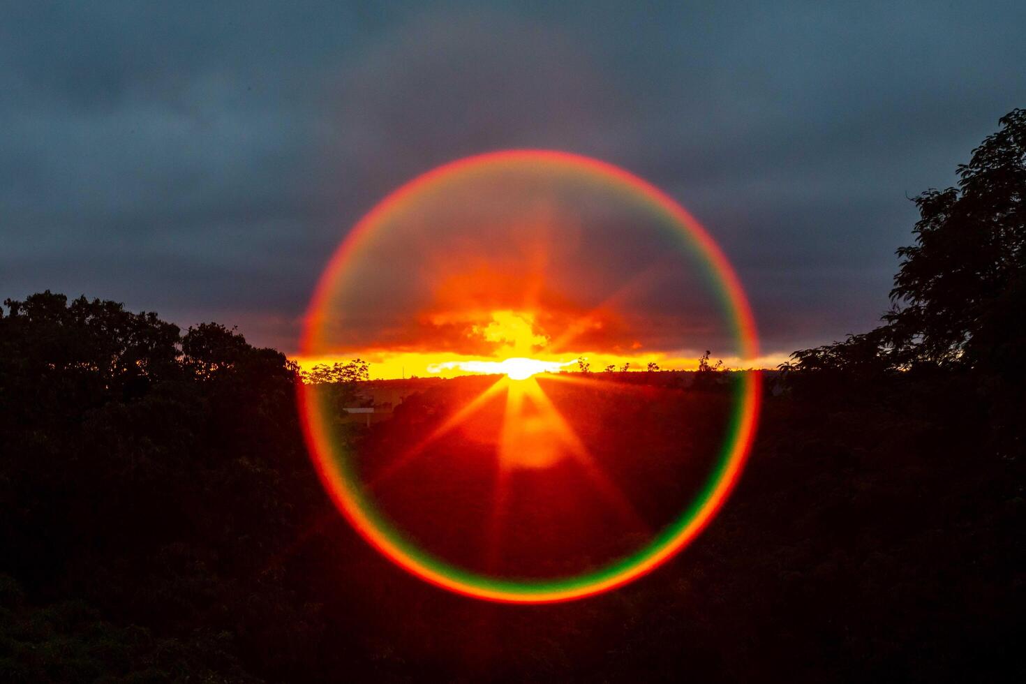 Stunning circular sunbeam with polarized circular rainbow colors photo