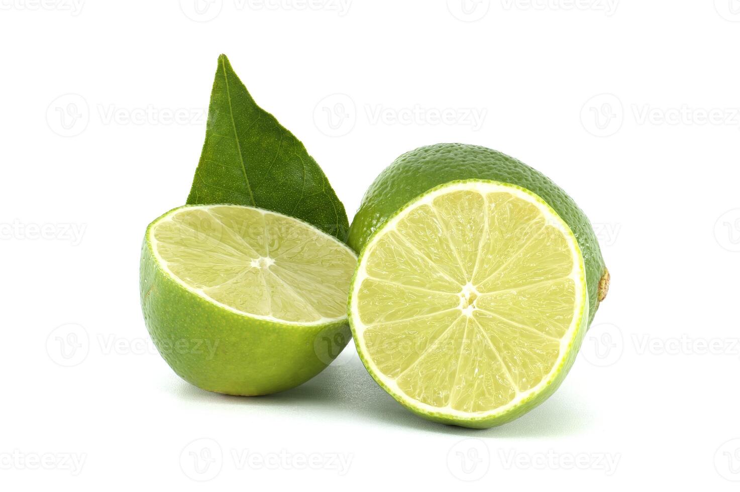 Fresh lime cut in half showing pulp and leaf on white background photo