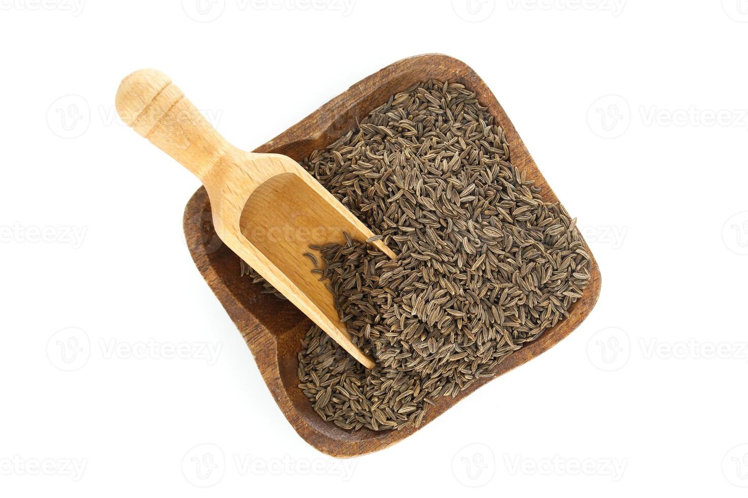Caraway seeds in wooden bowl with scoop on white background photo